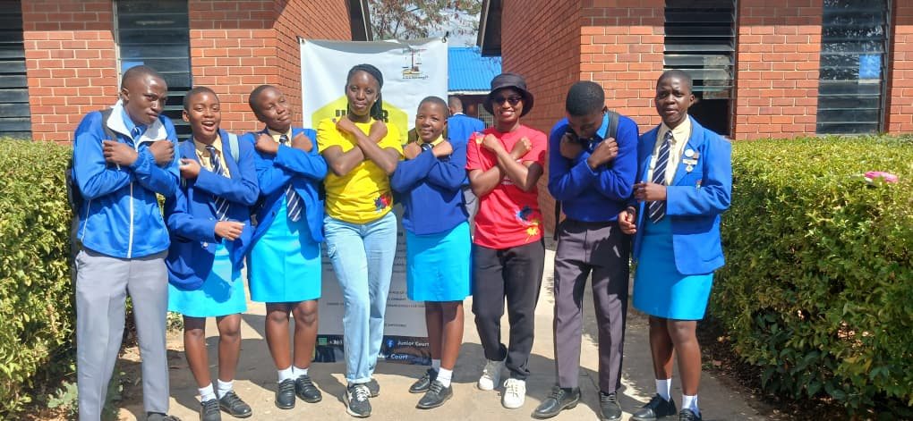 JCC team members posing with Zengeza 1 High School students outside the school building