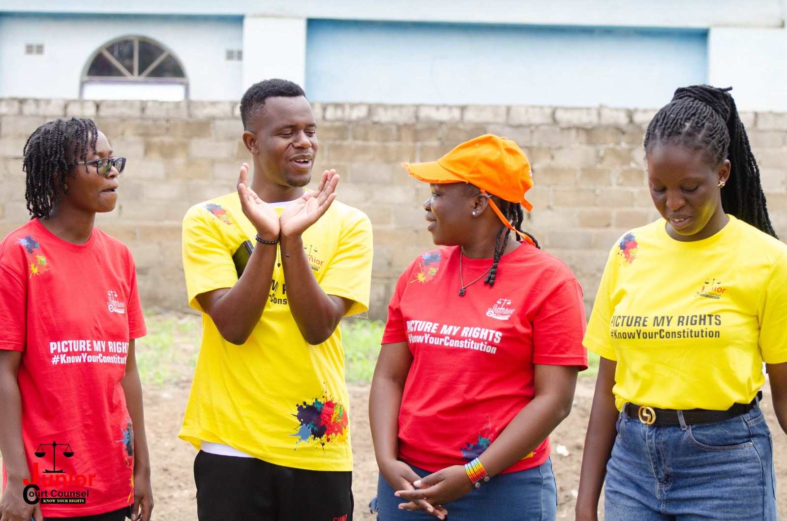 A JCC volunteer team laughing together outdoors before an outreach session